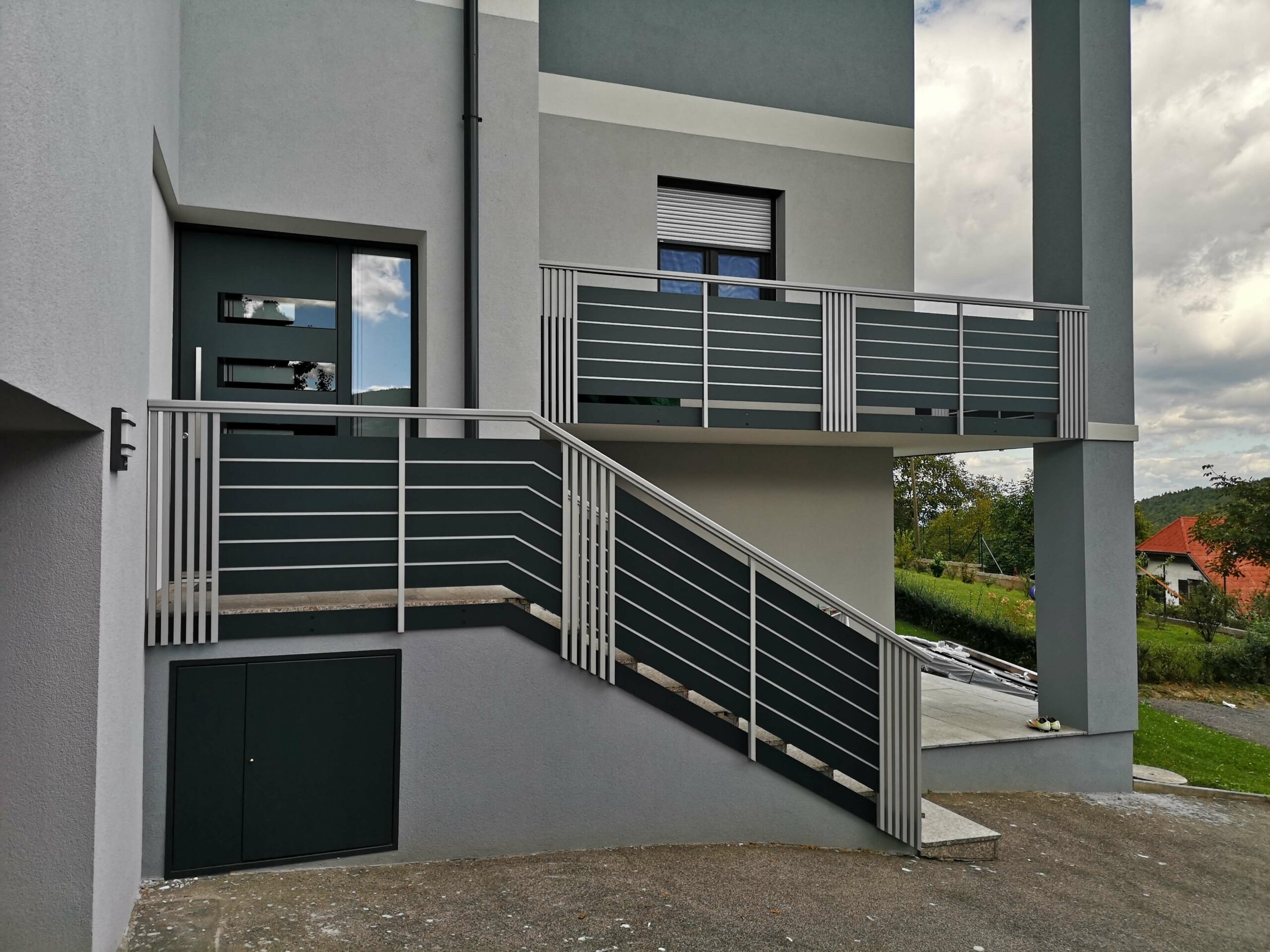 Grauer Alubalkon- und zaun an einem grauen Haus